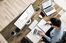 man at desk doing math