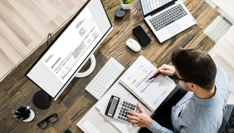 man at desk doing math