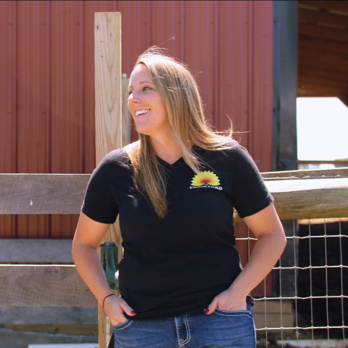 Renee Wilson standing in front of barn