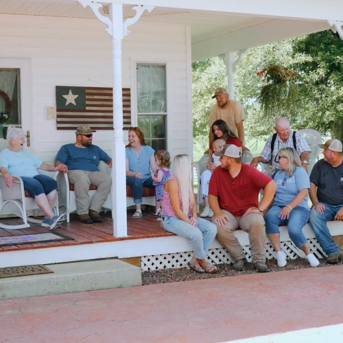 The Lucas Family Sitting on Front Porch
